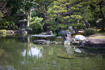Fototapeta na wymiar Corner of a traditional Japanese garden with a pond and stones. Tokyo, Japan.