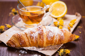 fresh hot tea with croissant