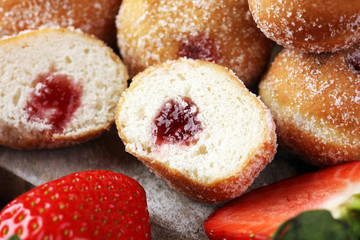 Bomboloni - traditional Italian doughnuts stuffed with strawberry jam