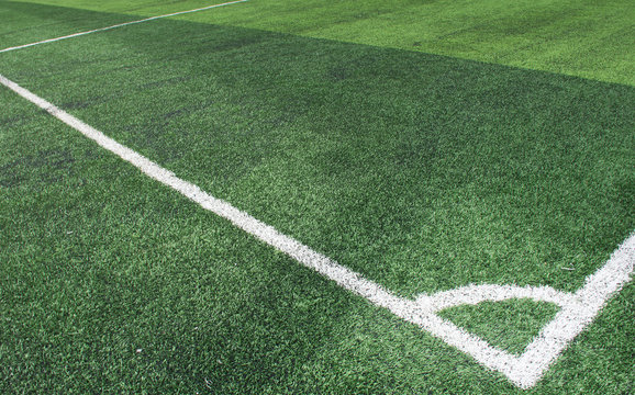 Soft focused picture of  The corner of Football field  or soccer field covered with artificial grass