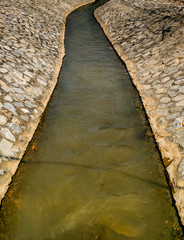 Irrigation canal with stone wall