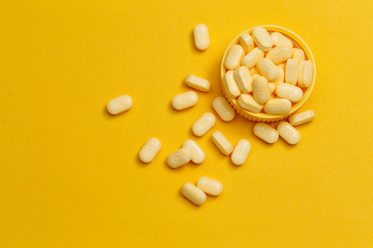 Vitamin B Tablets On Yellow Background