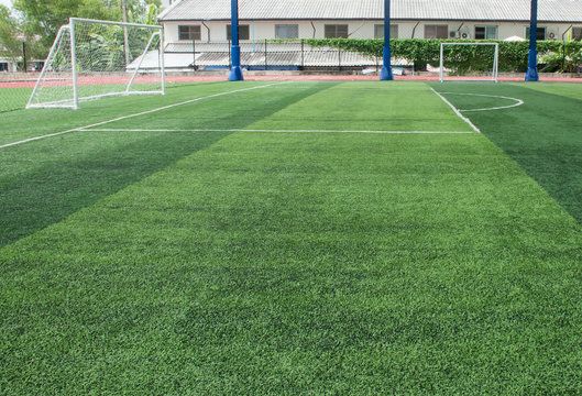 Soft focused picture of  Football field  or soccer field covered with artificial grass