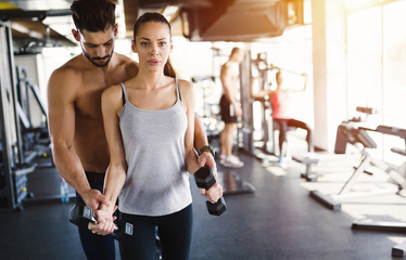 Personal trainer helping woman reach goals