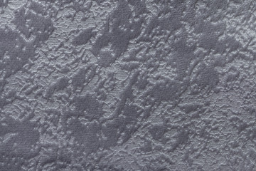 Gray background from a soft upholstery textile material, closeup.