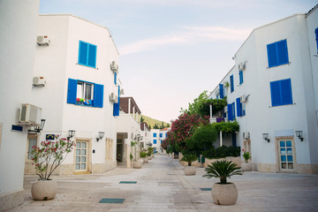 Fototapeta premium Cozy street with white buildings and landscaping at the resort in Montenegro