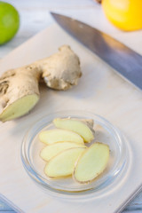 Ginger root slices on transparent glass plate.