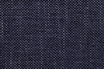 Denim textile background with checkered pattern, closeup. Structure of the fabric macro.