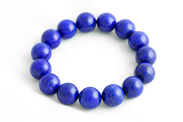 Beautiful high grade royal blue Lapis lazuli beads in bracelet on white background