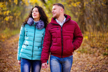 loving couple walking in the autumn forest