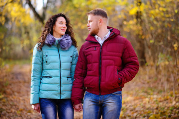 Fototapeta premium loving couple walking in the autumn forest