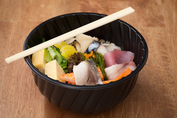 Japanese food Tekka Don take away on wooden background