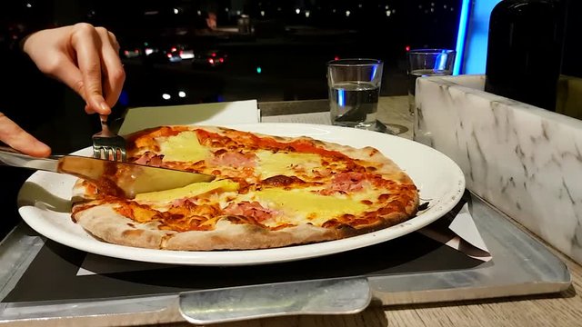 Woman Eating Pizza In Restaurant