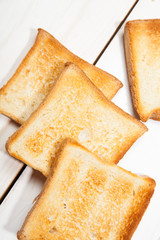 Toast bread on a white wooden background