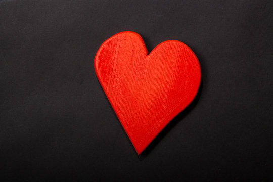Holidays gift and heart on a black background. Valentines day