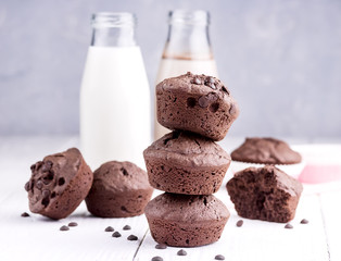 Chocolate muffin with two bottle of milk Chocolate milk Wooden background