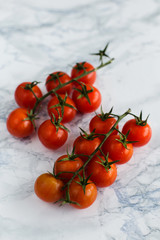 The cherry tomatoes on marble background