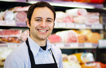 Smiling shopkeeper in a butchery