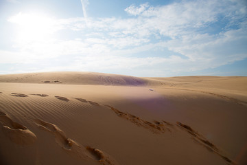 Foot prints on sand dune and blue sky, at Mui-Ne city, Vietnam
