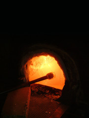Furnace with glass blowpipe in a glass blowing workshop
