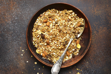 Homemade delicious granola in a clay bowl .Top view with space for text.