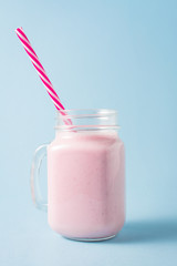 Jar of milk shake with fresh strawberries
