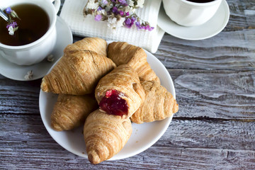 Fresh croissants with fruit tea
