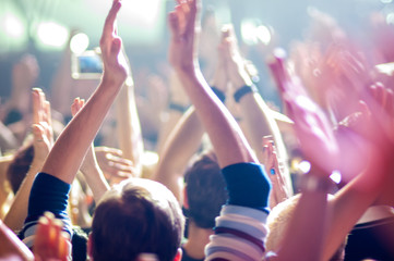 hands fans at a concert