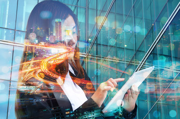 Double Exposure of Business Woman use Wireless Digital Mobile Tablet with Expressway or Highway in Modern city