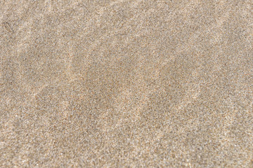 Close up of sand on a beach, sandy beach background