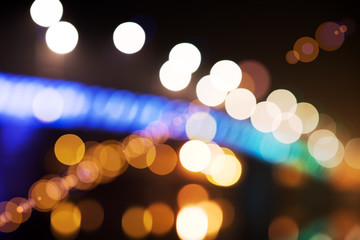 Blurred background of night city lights - lens-bokeh of a night skyline riverside