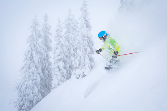 Freeride Skiier Riding In Deep Powder Snow