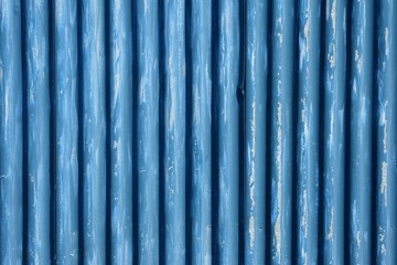Corrugated metal sheet fence with peeling away paint

