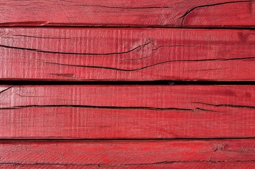 Red painted cracked wooden boarding texture
