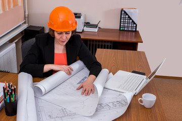 Female designer looks at the drawing