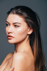 Fototapeta premium Close up of face beauty girl skin on grey background. Cosmetics or spa, healtcare concept.