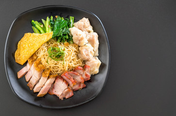 Egg noodle with red roast pork, crispy pork, dumplings and soup