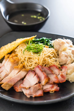 Egg noodle with red roast pork, crispy pork, dumplings and soup