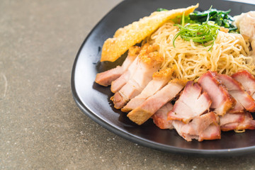 Egg noodle with red roast pork, crispy pork, dumplings and soup