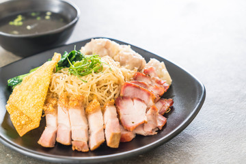 Egg noodle with red roast pork, crispy pork, dumplings and soup