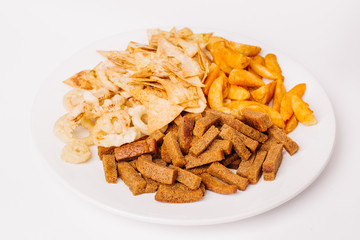Fast food snacks composition with onion rings,  crackers, baked potatoes, chips, toast.