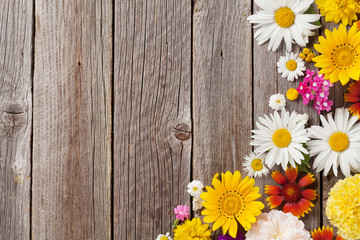 Garden flowers over wooden background