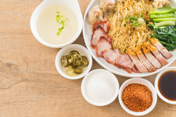 Egg noodle with red roast pork, crispy pork, dumplings and soup