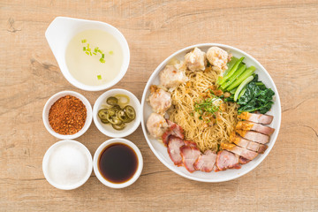 Egg noodle with red roast pork, crispy pork, dumplings and soup