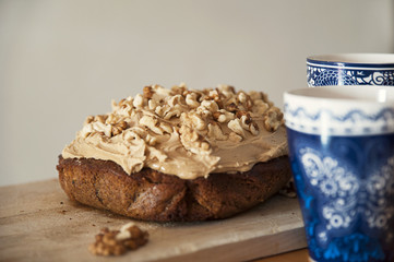 Delicious homemade walnut and coffee cake with cups of coffee aside