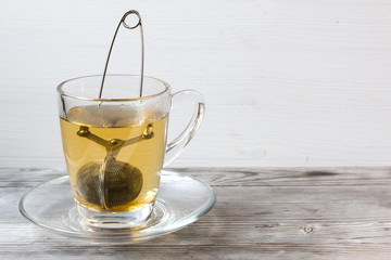 Green tea. Strainer. Grey wooden background. Copy space
