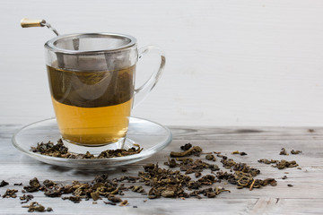 Green tea. Strainer. Grey wooden background. Copy space