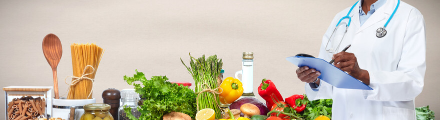 Doctor hands over food background