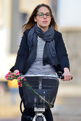 Young woman on a bicycle. - obrazy, fototapety, plakaty