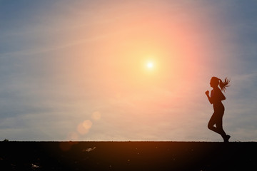 Woman running alone at beautiful sunset